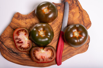 Fresh ripe sweet reddish brown and green kumato tomatoes close up