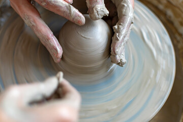 Making of mud pot on potters wheel during workshop in art ceramic atelier in Poland
