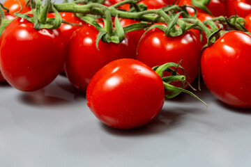 Red ripe tasty Dutch tomatoes growing indoor in greenhouse all seasons, food industry in Netherlands close up