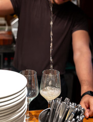 Pouring of txakoli or chacolí slightly sparkling very dry white wine produced in Spanish Basque Country in typical pinchos bar in old part of San Sebastian or Donostia, Spain