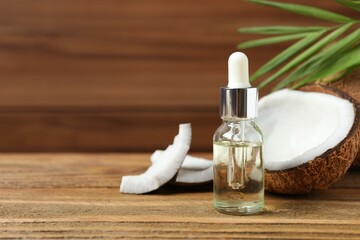 Skin care with facial serum. Glass bottle with pipette on a wooden background. Dry skin care product. Coconut essential oil moisturizing the skin of the body