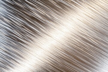 Obraz premium Stainless steel surface with subtle brushed patterns reflecting soft light, ideal for modern and industrial aesthetics