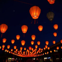 Obraz premium Floating Lanterns Illuminating the Night Sky Under a Starry Background