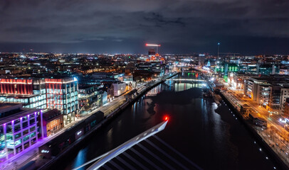 Aerial view of Dublin city illuminated at night during the Christmas season.