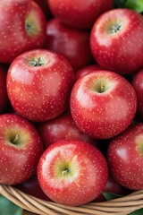 close-up of basket filled with freshly picked apples against blurred orchard background highlighting vibrant red and