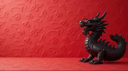 Fototapeta premium Black dragon statue on vibrant red background.