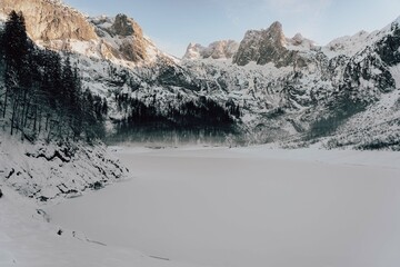 Fototapeta premium Mountain scenery in the Alps with Dachstein summit reflecting in Lake Gosausee, Salzkammergut, Austria in the Winter 