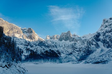 Mountain scenery in the Alps with Dachstein summit reflecting in Lake Gosausee, Salzkammergut, Austria in the Winter 