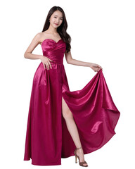 A woman in a floor-length, magenta satin dress with a thigh-high slit, poses confidently. She has long, dark hair. on white background