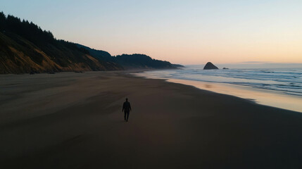 Solitary Figure Walking on a Serene Deserted Beach at Sunset