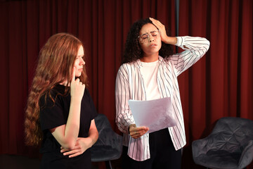 Professional actors rehearsing on stage in theatre