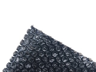 Black bubble wrap packaging isolated on white background with negative space for text 