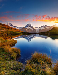 Fantastic evening panorama of Bachalp lake - Bachalpsee, Switzerland. Picturesque autumn sun