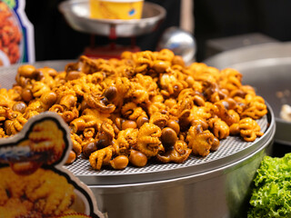 Baby octopus for sale at the night market. Street food in the market of Thailand.