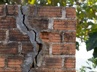 Old orange bricks and broken cement walls. Close-up of construction or repair of a wall.