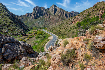 An epic view of an empty desert road in a desert canyon with mountains and rocks, little Karoo, South Africa, Africa