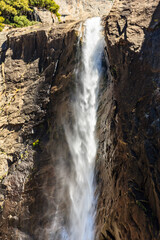 A waterfall is flowing down a rocky cliff
