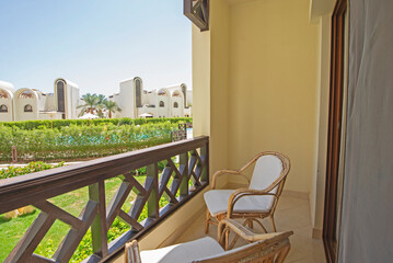 Terrace balcony with chairs in tropical luxury apartment resort