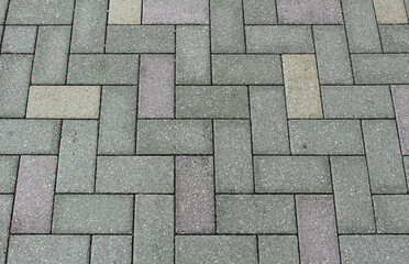 Green, gray and brown paving tile. Brick pavement texture. Interlocking concrete pavers background.