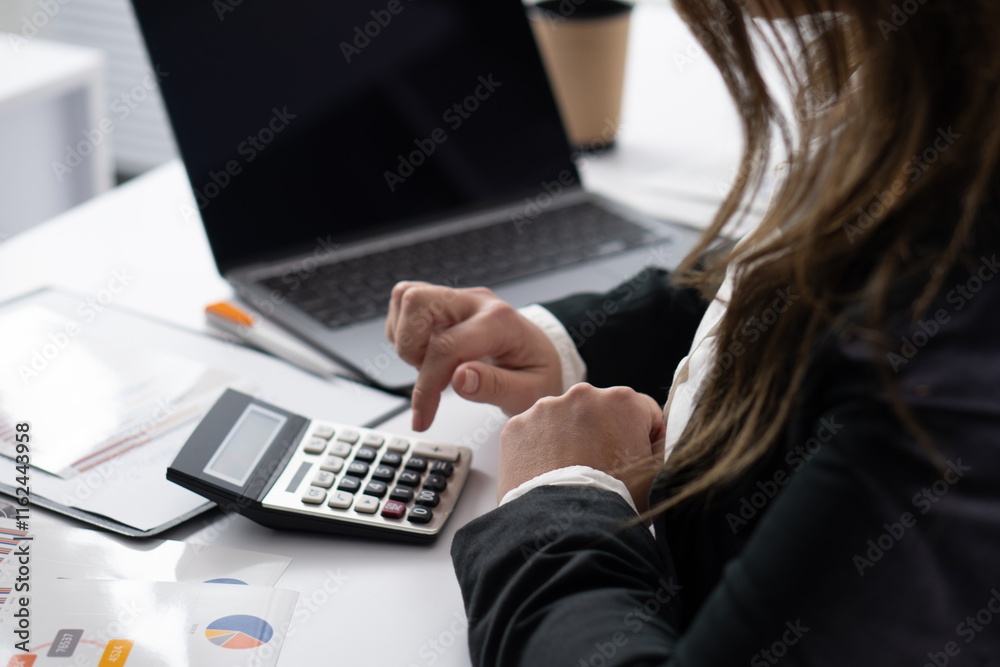 Poster a dedicated business professional is diligently calculating financial data utilizing a calculator, w