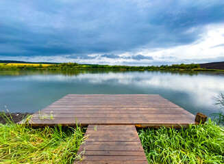 panorama with wooden pontoon overlooking the lake at sunset