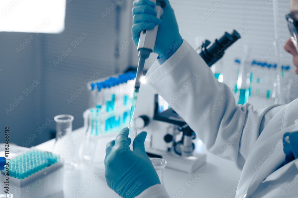 Aufkleber A skilled Laboratory Scientist expertly uses a pipette, an essential tool for precise liquid handling in experiments, ensuring accurate measurements for reliable results in research and testing