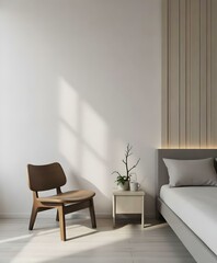 A minimalist bedroom with a wooden chair, a small tree, and a gray bed against a white wall