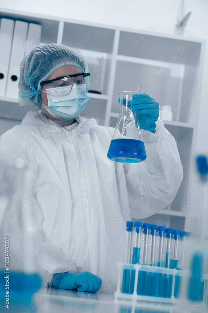 Poster A scientist is meticulously conducting an experiment in a modern laboratory, carefully handling a flask filled with a vibrant blue liquid, ensuring accuracy and safety as part of the research process