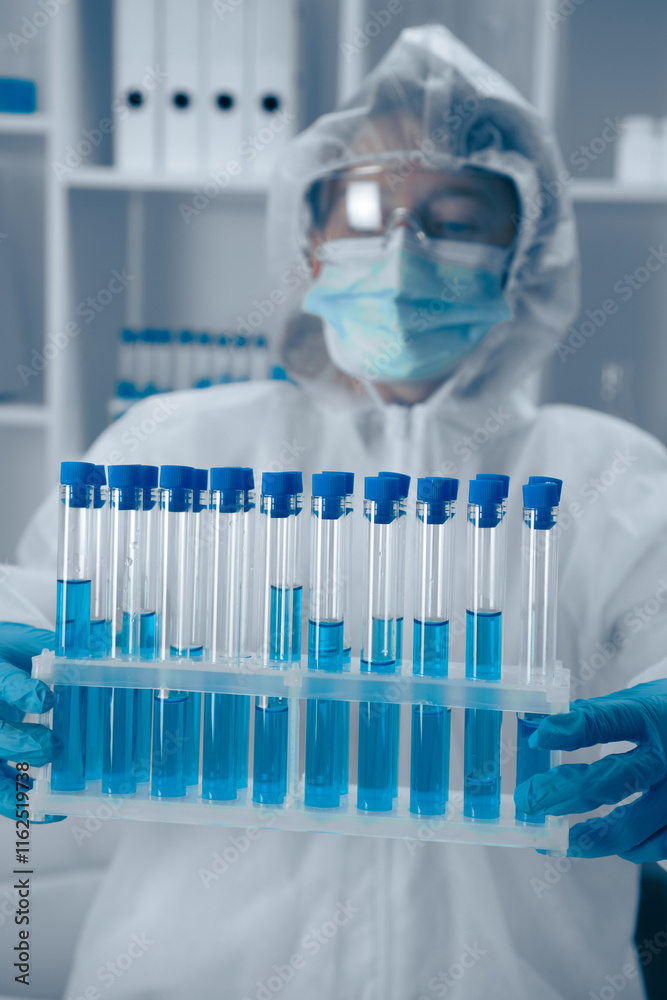 Poster a laboratory technician skillfully analyzing a variety of test tubes filled with vibrant blue soluti