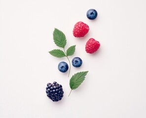 Asymmetrical Composition of One Blackberry, Three Raspberries, and a Blueberry with Leaves on White Background.