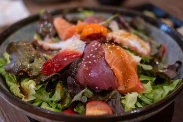 Salmon and tuna sashimi salad served on plate