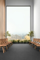 Modern waiting area with wooden chairs and large window overlooking serene landscape