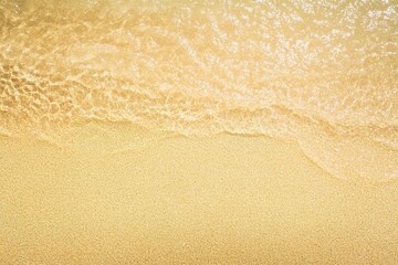 food photography of top-down view of wet shoreline sand with small pebbles illuminated by bright studio lighting warm