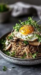 Soba noodles with fried egg, mushrooms and microgreens.