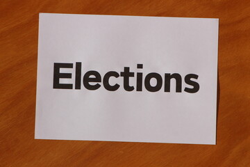 Elections word written on a white paper