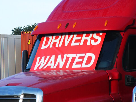 Drivers Wanted sign on red truck.