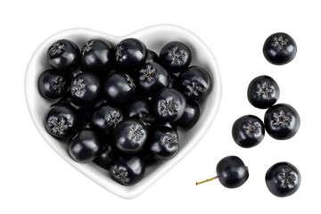 Chokeberry in ceramic bowl isolated on white background. Black aronia. Top view. Flat lay