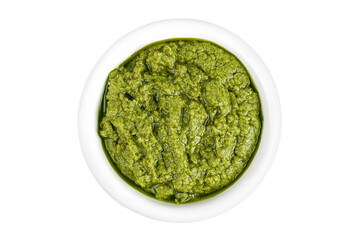 Pesto sauce in ceramic bowl isolated on white background. Top view. Flat lay