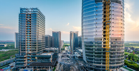 Modern city commercial building construction site at sunrise