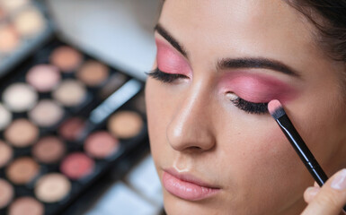 Close-Up Portrait of Young Woman with Wet Look Hair, Bold Red Lips and Confident Gaze