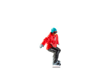 Miniature figurine depicting a snowboarder in mid-motion isolate on white background with clipping path
