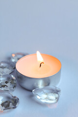 Candle and crystal stones on white background. Copy space for text.	