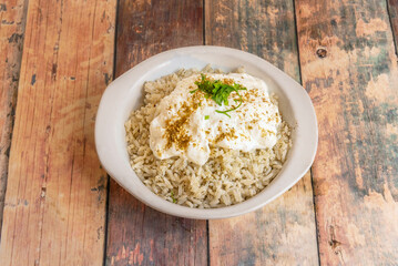 Recipe for rice with spices and yogurt in a white bowl