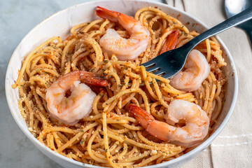 spaghetti top with  shrimp parsley and cheese,