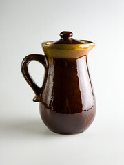 Ceramic dishes on a white background, Clay Jug. Vertical photo