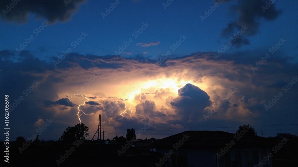 Poster a dramatic sunset behind clouds with lightning, creating a striking natural scene.