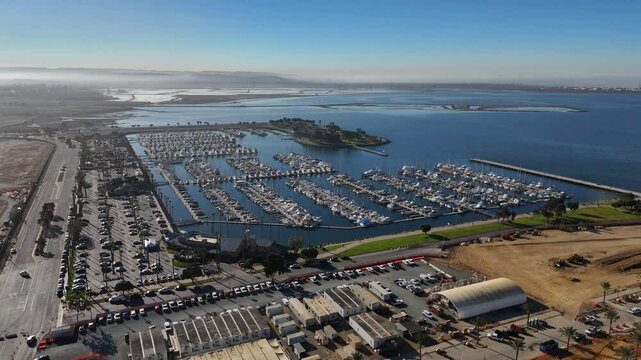 Aerial drone view of Chicano Park Murals with aligned boats and yachts in San Diego, CA