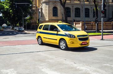 Rio de Janeiro. Yellow taxi in Rio de Janeiro navigating through city streets during daytime. Brazil © Sergey