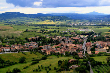 Obraz premium Aerial landscape view of one of the towns in the suburbs of Orvieto against the backdrop of mountains and a stormy sky in the Umbria region, Italy