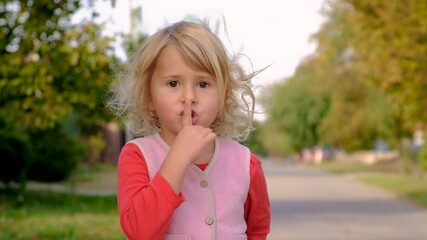 The child points his finger quietly. Selective focus.